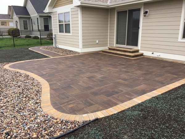 Concrete paver patio installed by J.T. & Sons Lawn Care exemplifies their new landscaping & hardscaping service available to residents in the Bloomington-Normal, IL area.