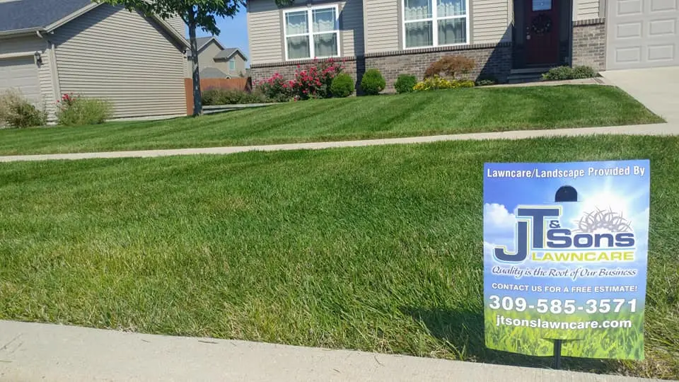 J.T. & Sons Lawn Care mowing lawn in Normal, IL.